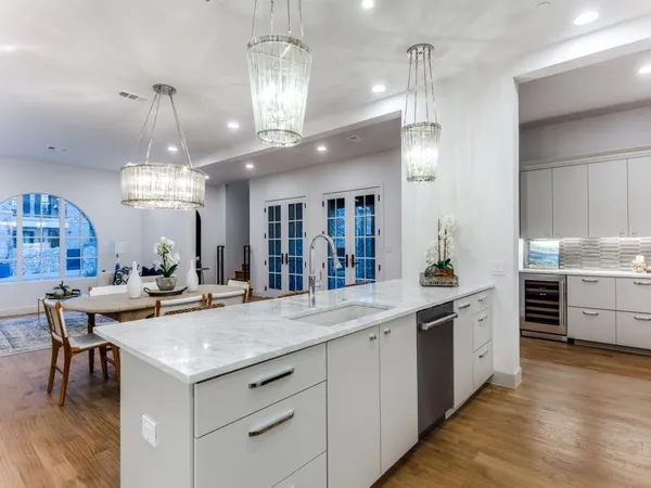 a kitchen with center island wooden floor center island and cabinets