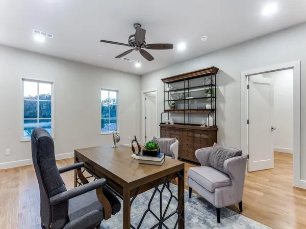 a living room with furniture and a wooden floor