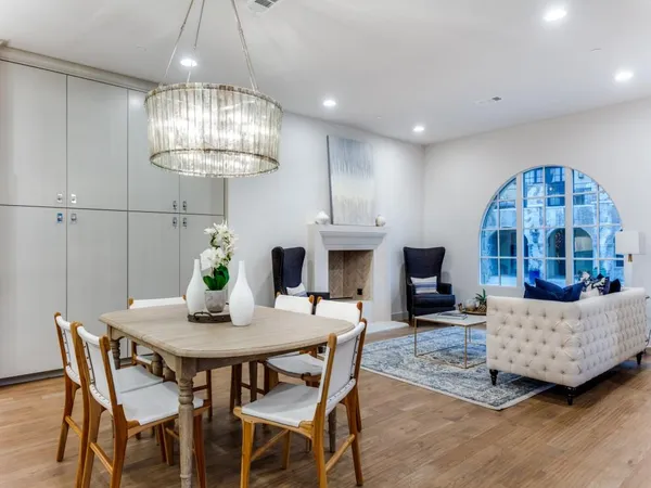 a view of a dining room with furniture a chandelier and wooden floor