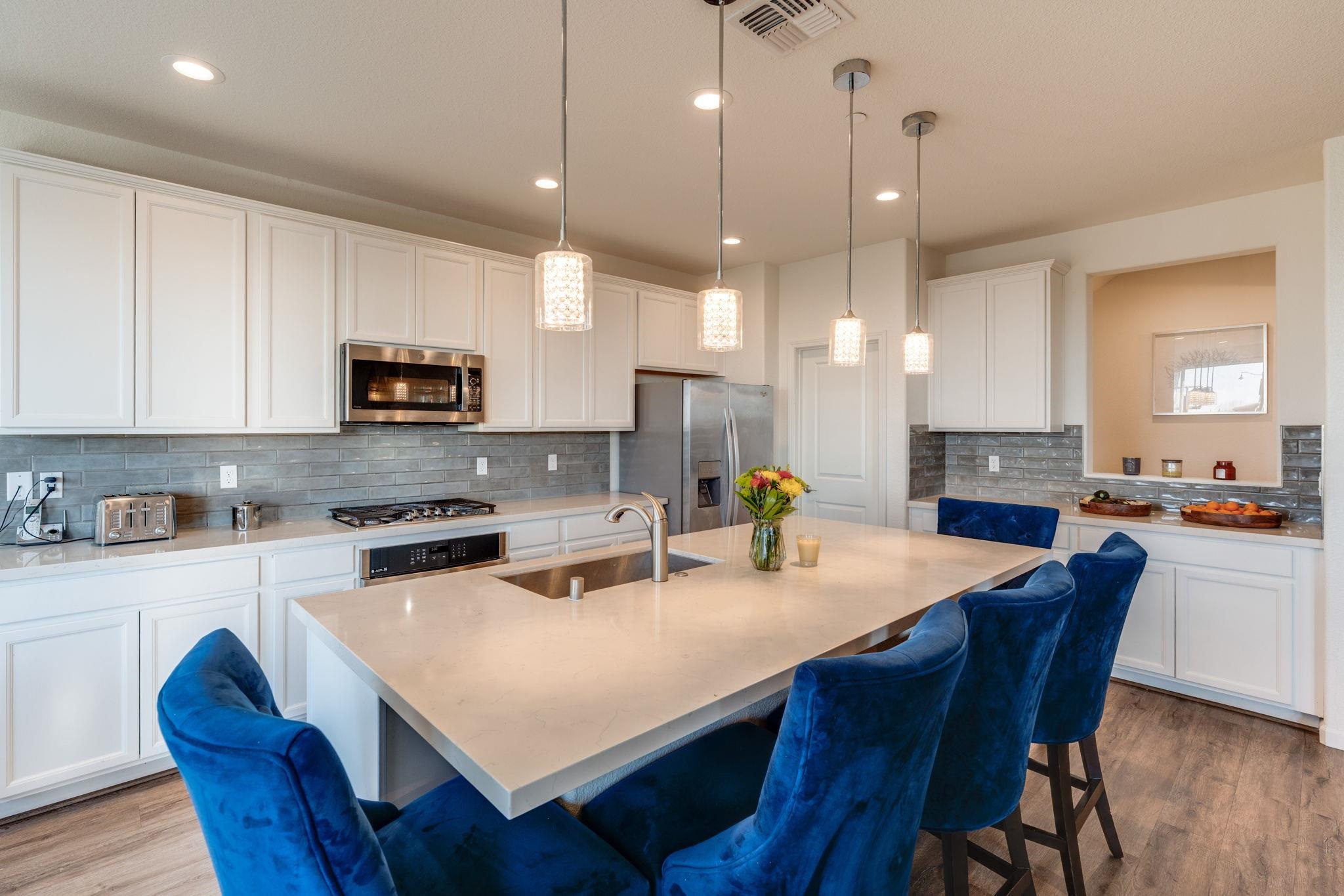 1305 Stark Bridge Road Lincoln, CA 95648 - Photo 19 of 53 a kitchen with sink a stove a refrigerator and white cabinets with wooden floor