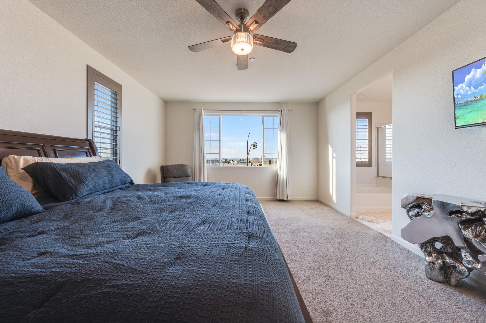 1305 Stark Bridge Road Lincoln, CA 95648 - Photo 25 of 53 a spacious bedroom with a bed and a chandelier
