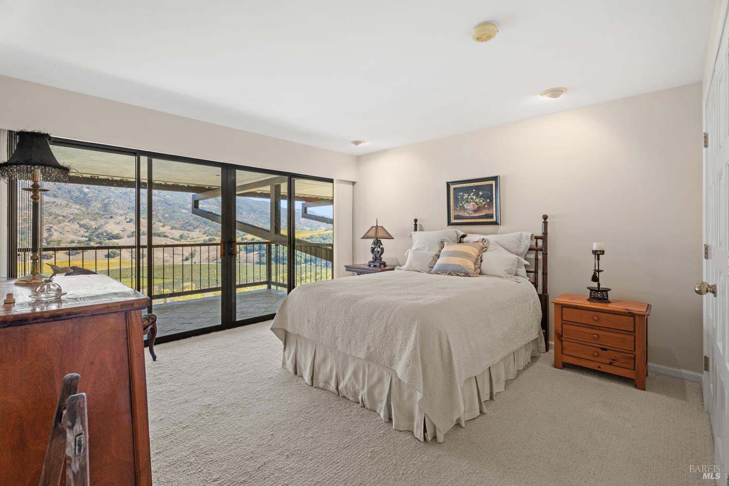 241 Henry Station Road Ukiah, CA 95482 - Photo 51 of 76 a spacious bedroom with a bed and a large window