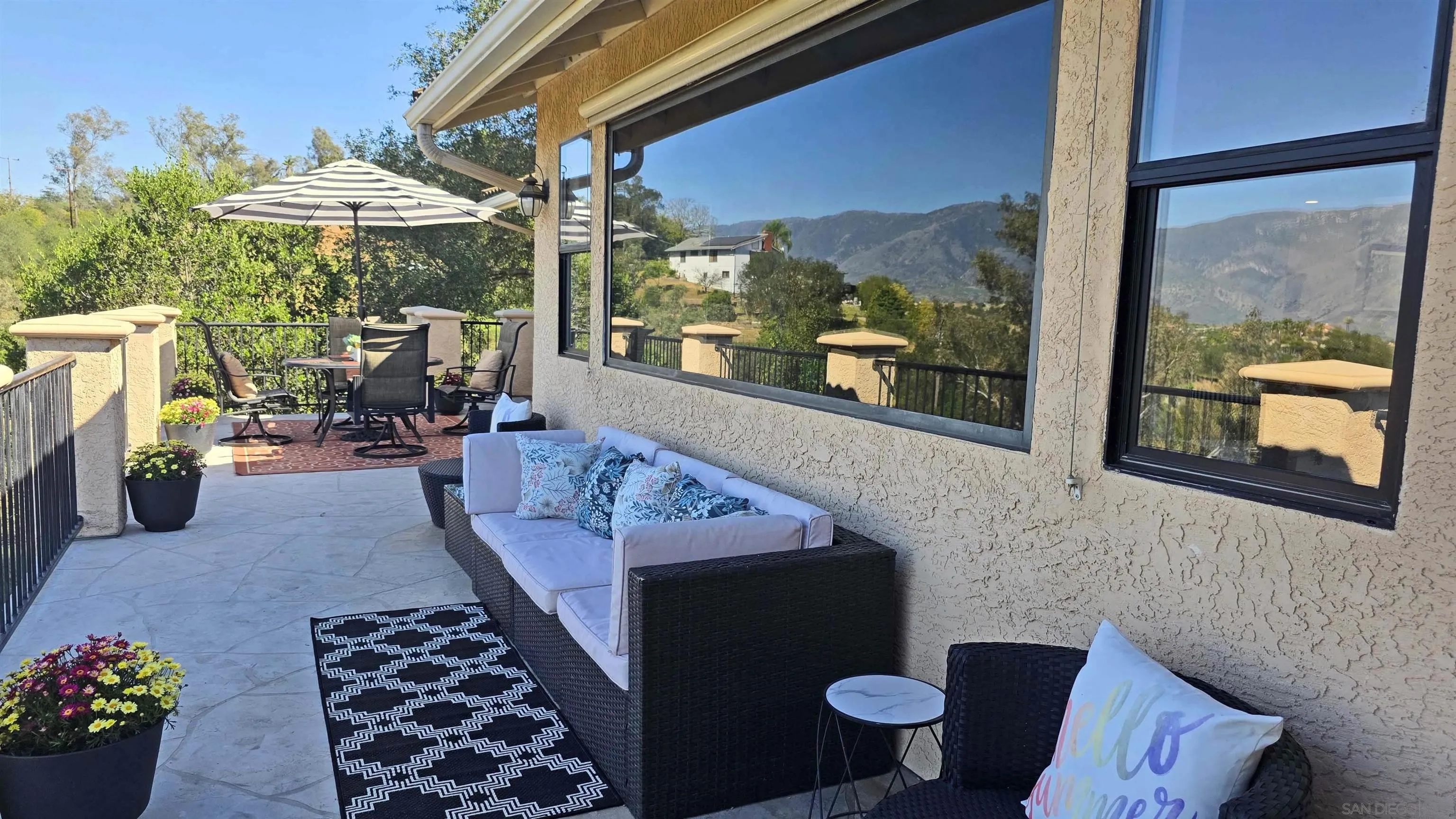 13588 McNally Road Valley Center, CA 92082 - Photo 9 of 43 a view of a patio with a dining table and chairs