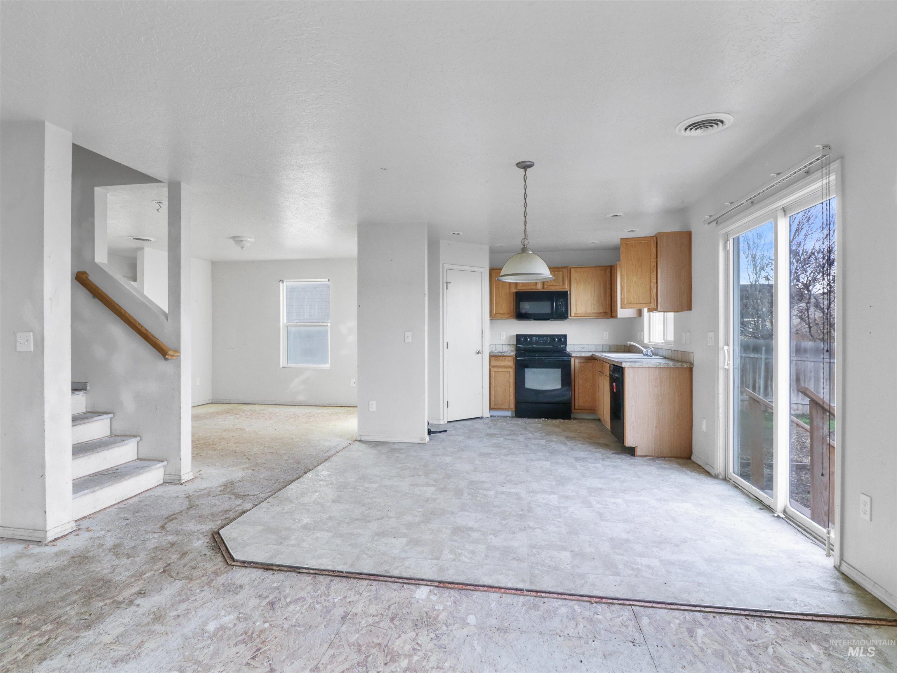 4415 Duke Street Caldwell, ID 83607 - Photo 22 of 22 Kitchen with light countertops, black appliances, pendant lighting, brown cabinets, and open floor plan
