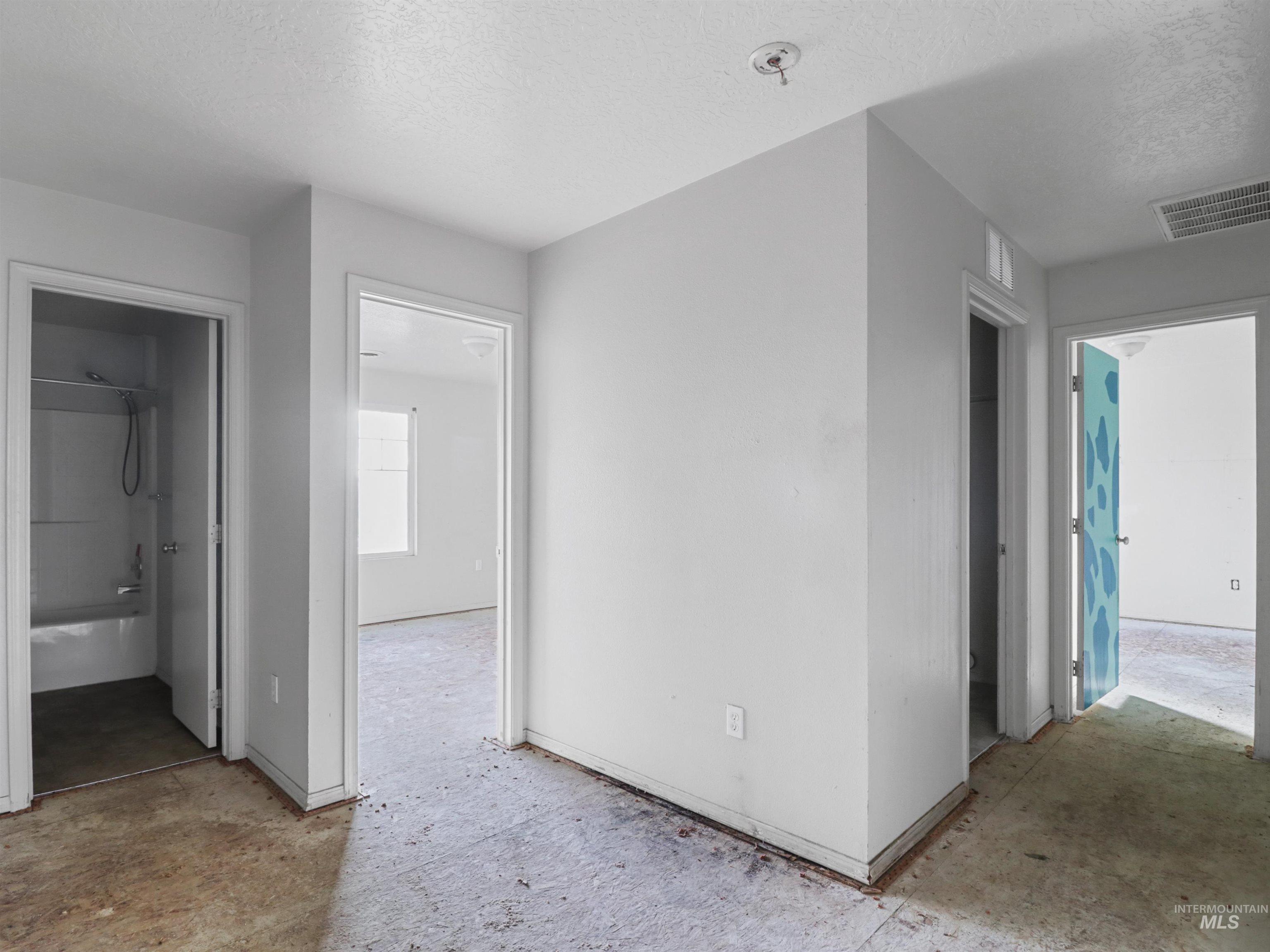 4415 Duke Street Caldwell, ID 83607 - Photo 18 of 22 Corridor featuring a textured ceiling