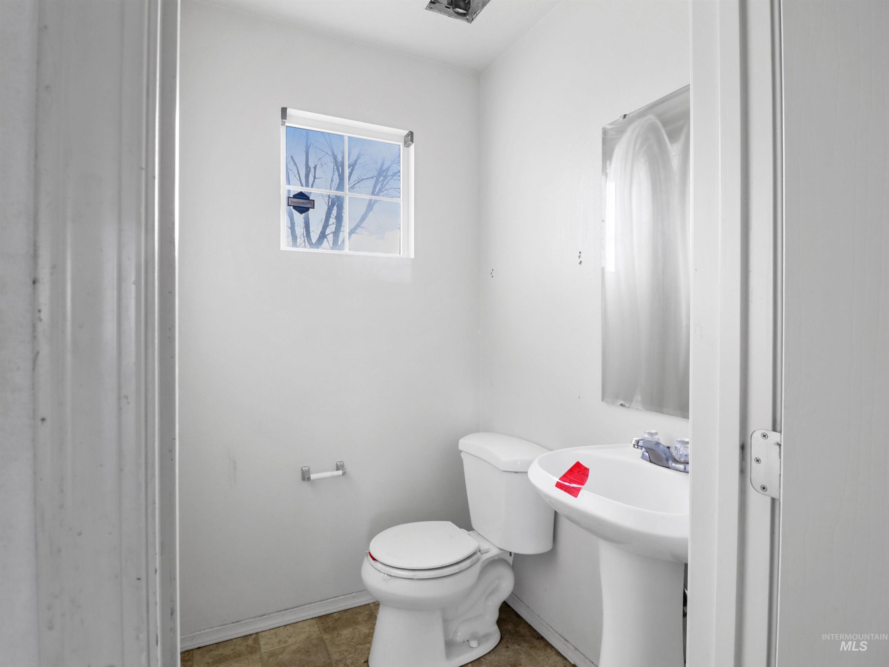 4415 Duke Street Caldwell, ID 83607 - Photo 8 of 22 Half bath with toilet and baseboards