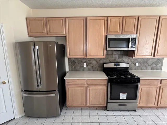 a kitchen with a refrigerator sink and microwave