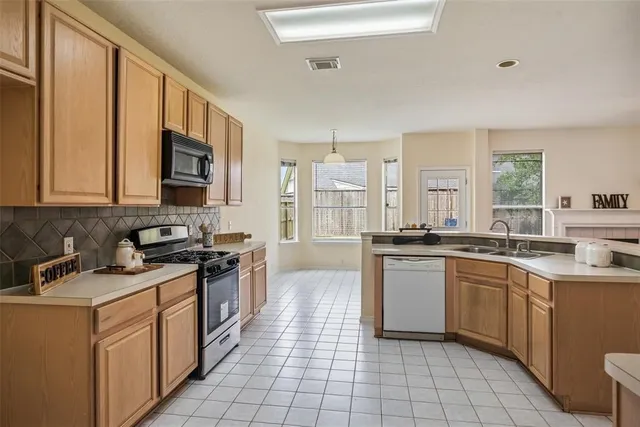 a kitchen with a sink stove and cabinets
