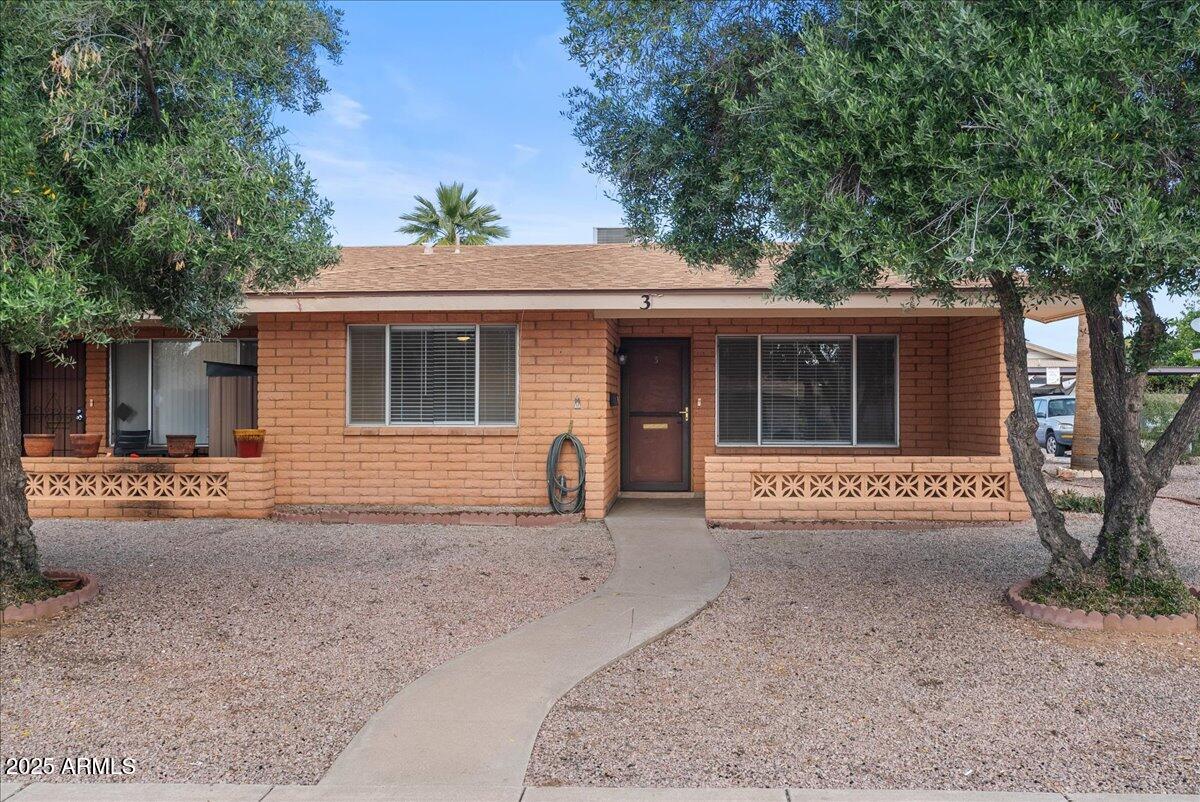 6438 East Butte Street, Unit 3 Mesa, AZ 85205 - Photo 1 of 24 a view of a house with a yard and large tree