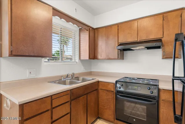 a kitchen with a refrigerator stove and cabinets