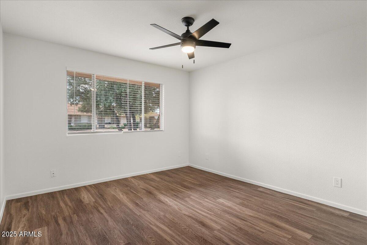 6438 East Butte Street, Unit 3 Mesa, AZ 85205 - Photo 13 of 24 an empty room with wooden floor and windows