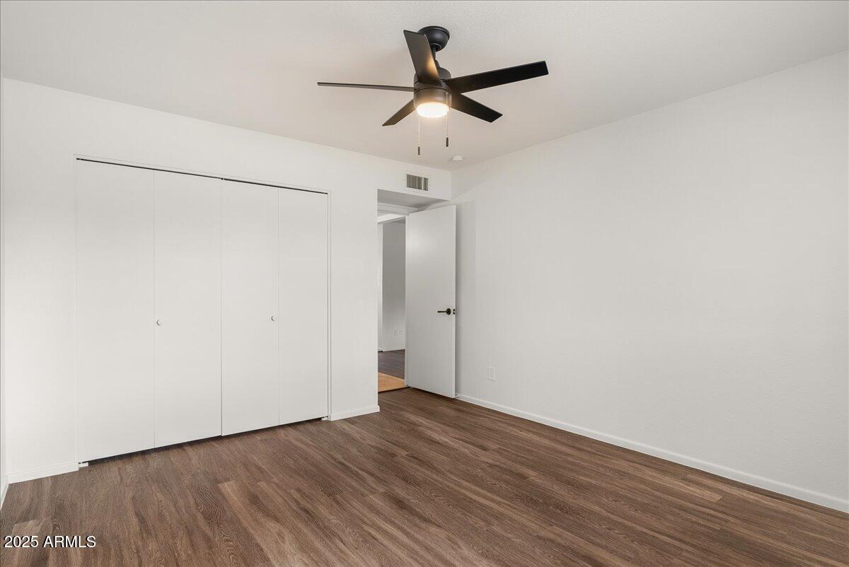 6438 East Butte Street, Unit 3 Mesa, AZ 85205 - Photo 14 of 24 a view of a room with wooden floor and white walls
