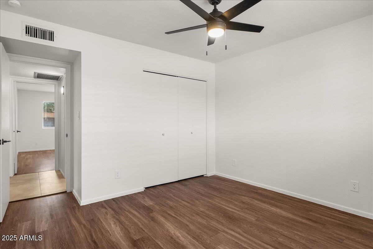 6438 East Butte Street, Unit 3 Mesa, AZ 85205 - Photo 17 of 24 an empty room with a hardwood and ceiling fan
