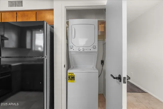 an empty room with a hardwood and ceiling fan