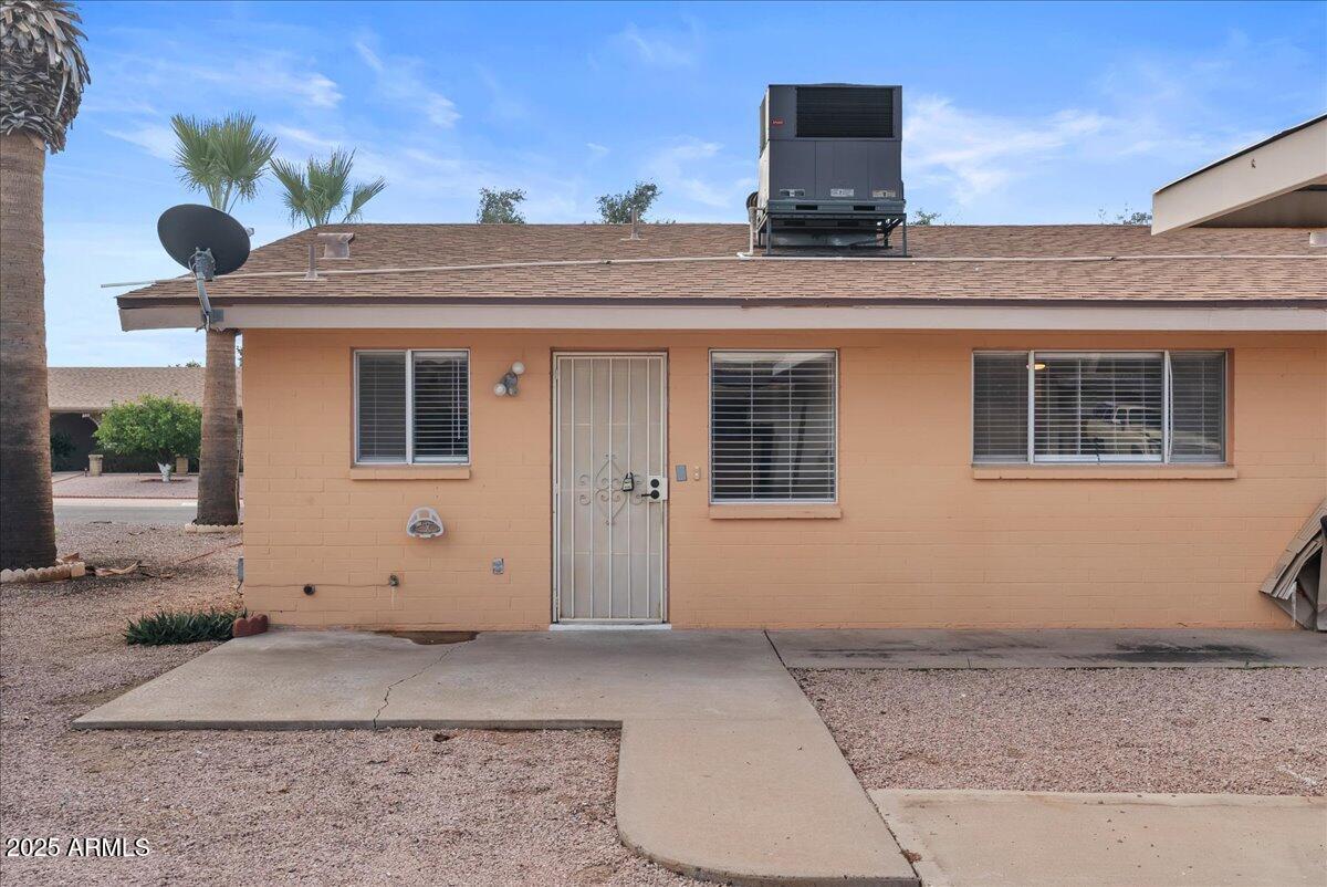 6438 East Butte Street, Unit 3 Mesa, AZ 85205 - Photo 19 of 24 a front view of a house with a garage