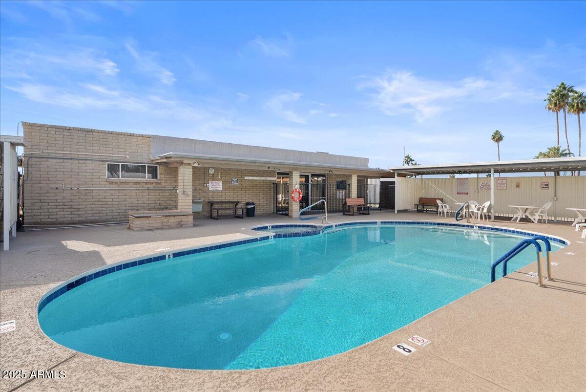 6438 East Butte Street, Unit 3 Mesa, AZ 85205 - Photo 22 of 24 a view of a house with swimming pool