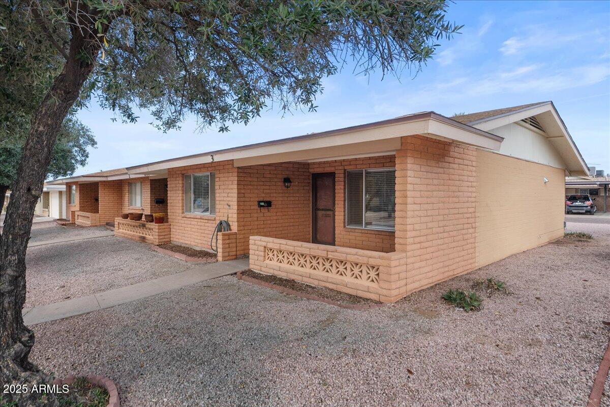 6438 East Butte Street, Unit 3 Mesa, AZ 85205 - Photo 2 of 24 a view of a house with a yard
