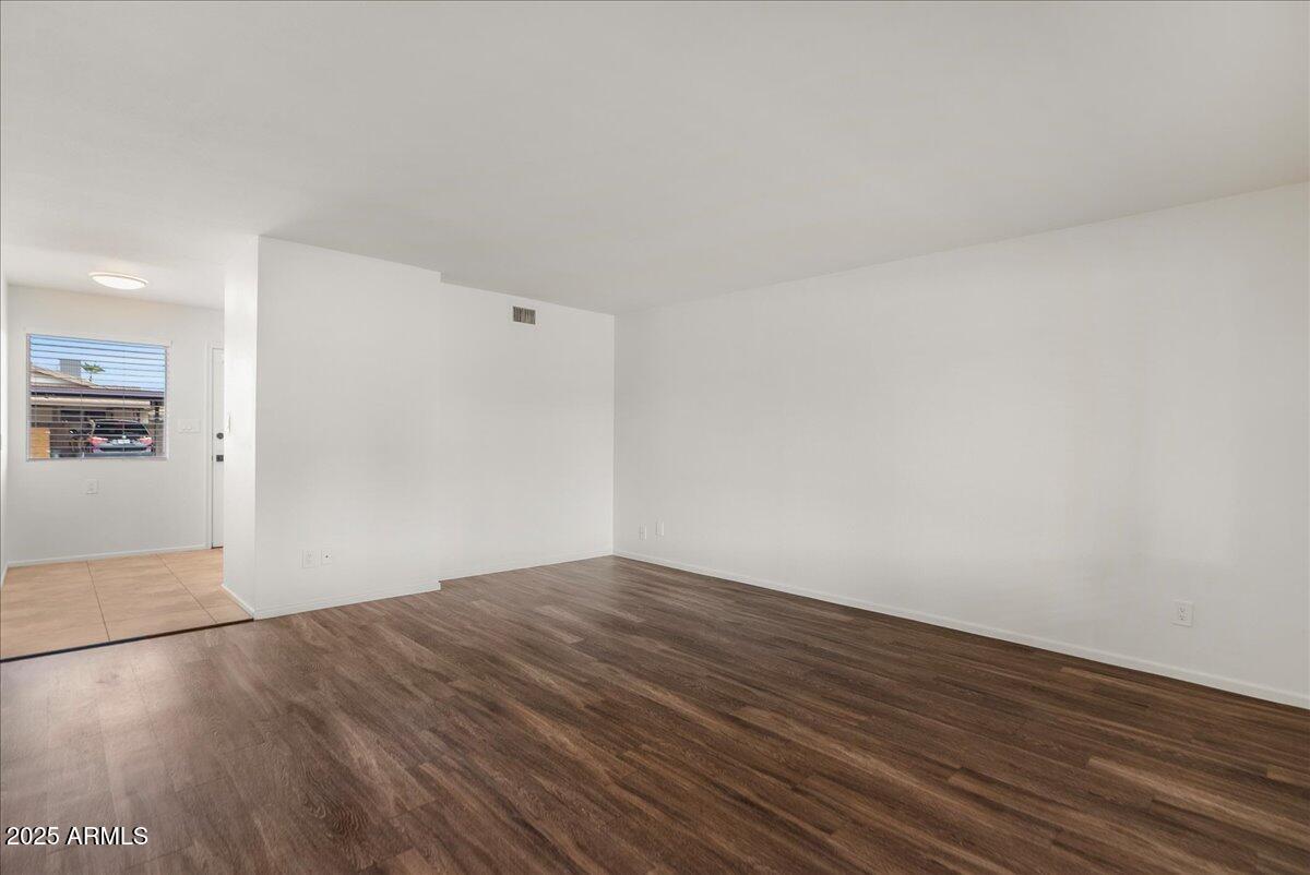 6438 East Butte Street, Unit 3 Mesa, AZ 85205 - Photo 4 of 24 wooden floor in a empty room