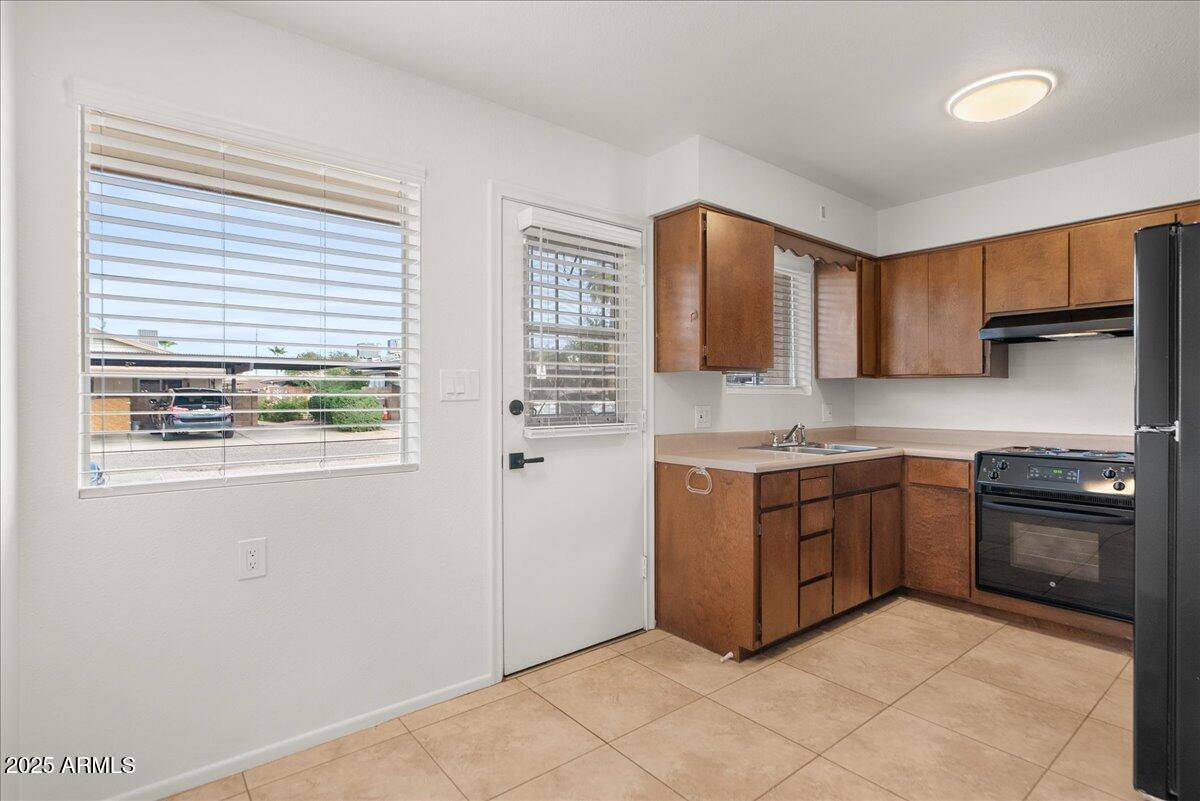 6438 East Butte Street, Unit 3 Mesa, AZ 85205 - Photo 7 of 24 a kitchen with stainless steel appliances granite countertop a stove and a sink