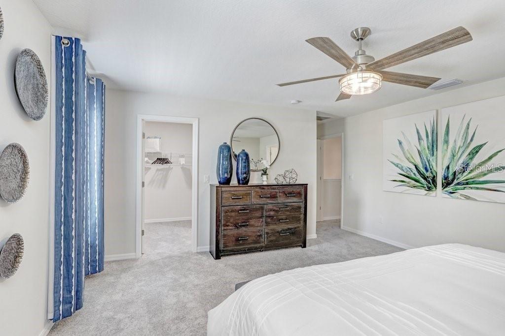 5341 Coldpine Place Seffner, FL 33584 - Photo 16 of 24 a bedroom with a bed and a chandelier