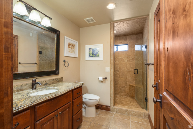 892 Cambridge Drive St. George, UT 84770 - Photo 44 of 65 Spacious bathroom featuring a glass-enclosed shower with tiled walls and a built-in bench