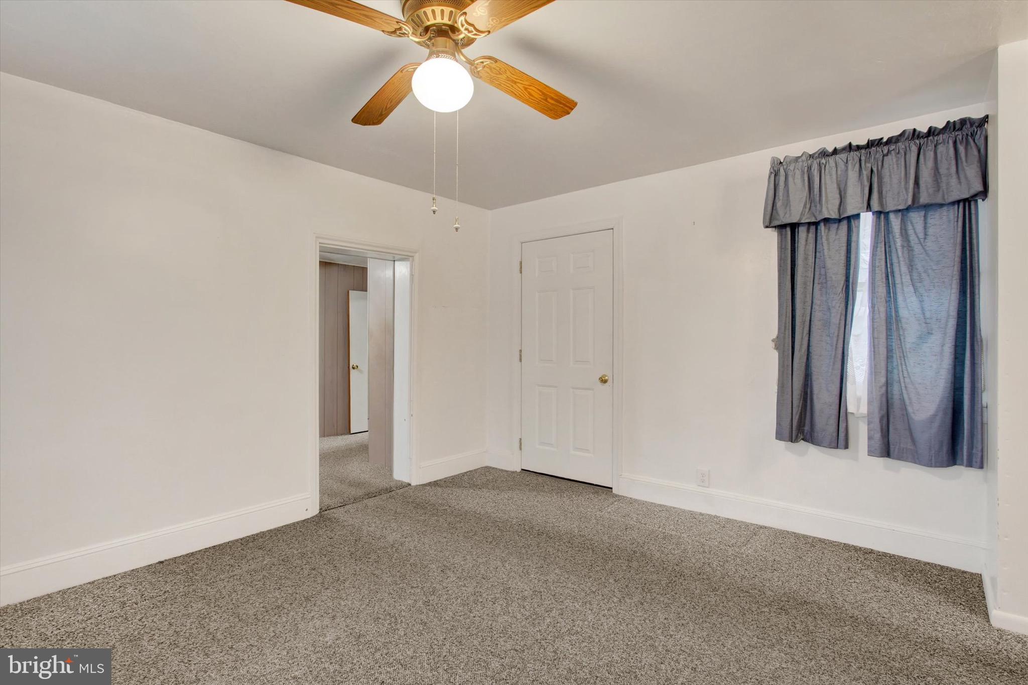 22 Cemetery Street Littlestown, PA 17340 - Photo 22 of 34 an empty room with chandelier fan and windows
