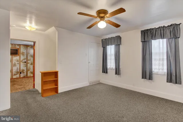 a view of a bathroom with a shower and a mirror