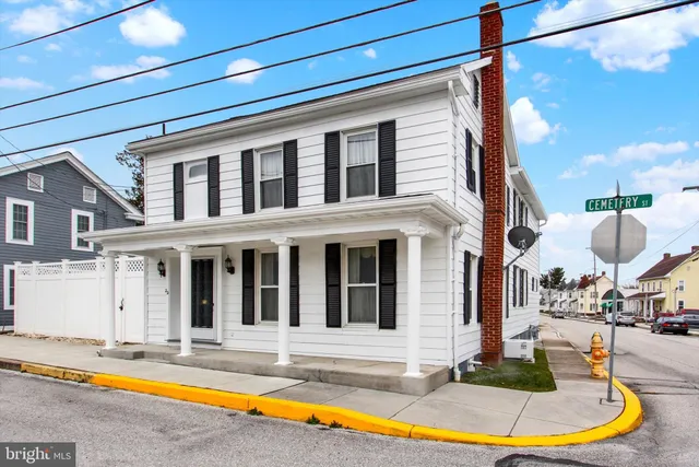 a view of a house with swimming pool and sitting area