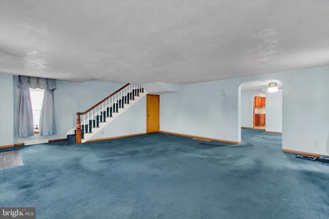 a view of an empty room with stairs
