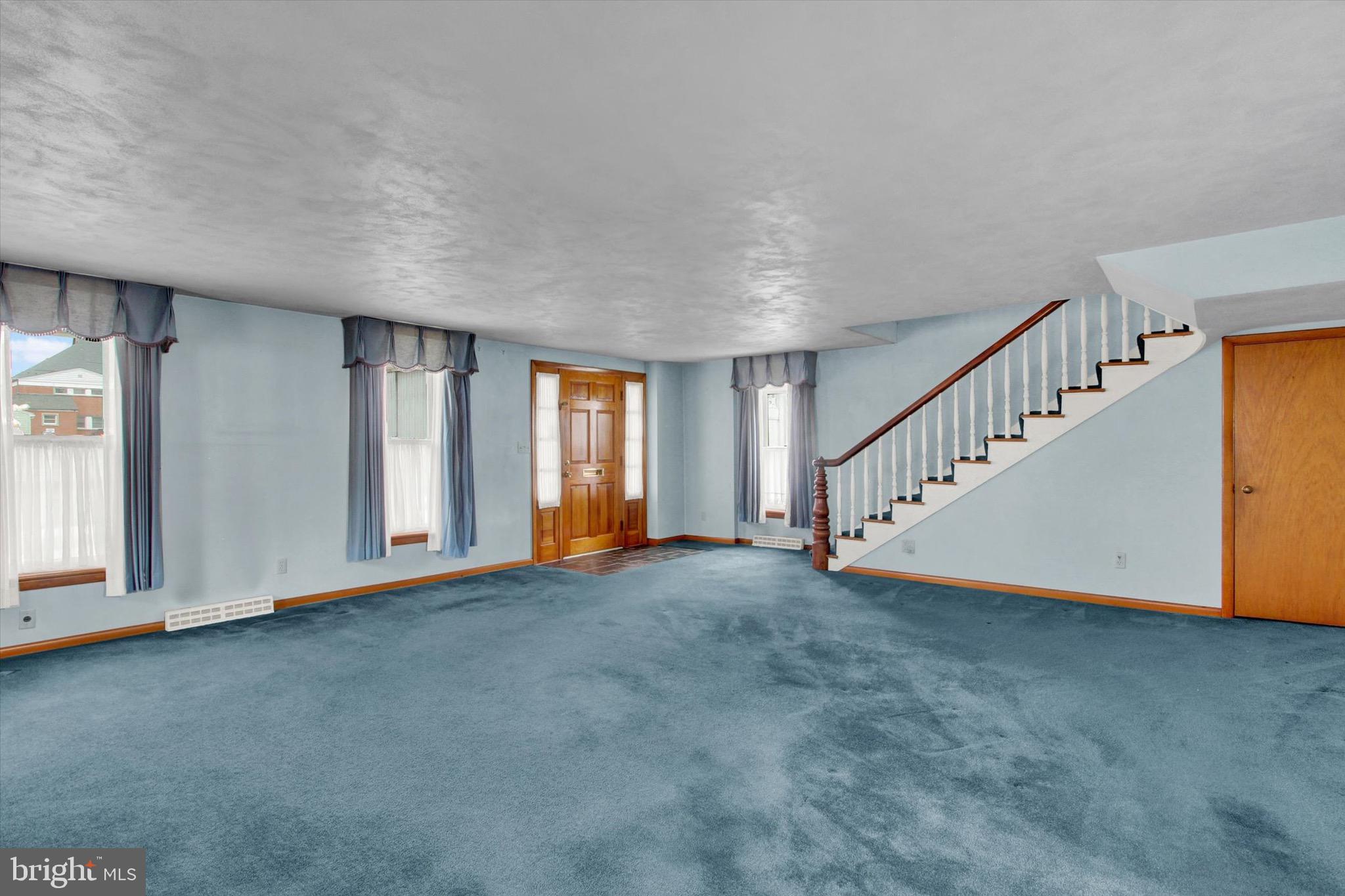 22 Cemetery Street Littlestown, PA 17340 - Photo 6 of 34 a view of an empty room with wooden floor and stairs