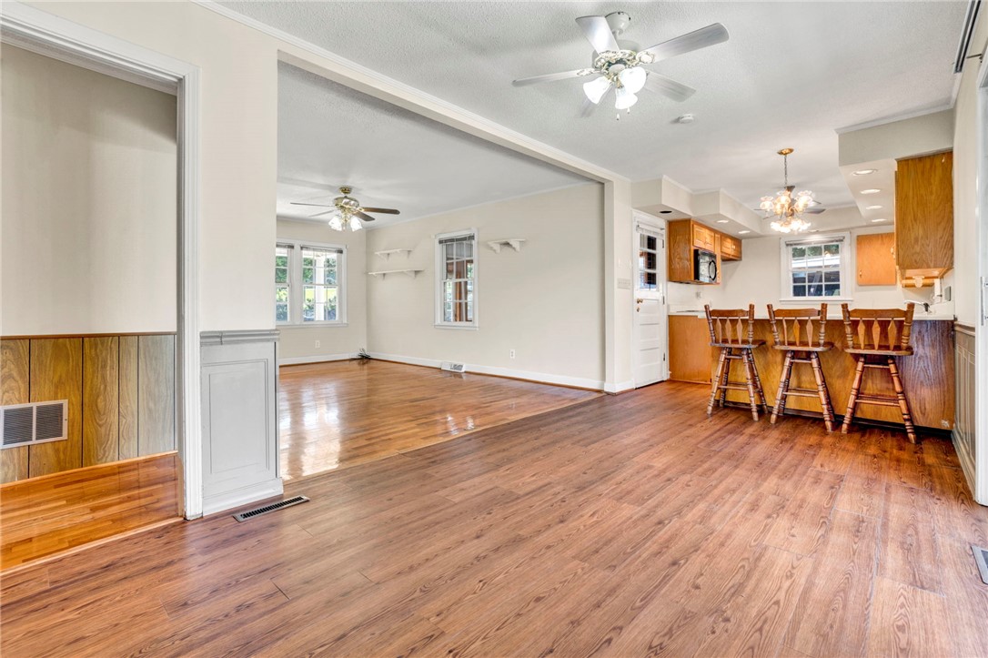 7876 Highway 11 Walhalla, SC 29691 - Photo 35 of 35 An open floorplan seamlessly connects the inviting living spaces with rich wood flooring throughout.