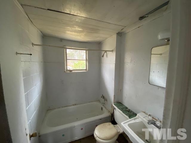 611 Jean Street Roxboro, NC 27573 - Photo 7 of 7 a bathroom with a bathtub shower sink vanity and toilet