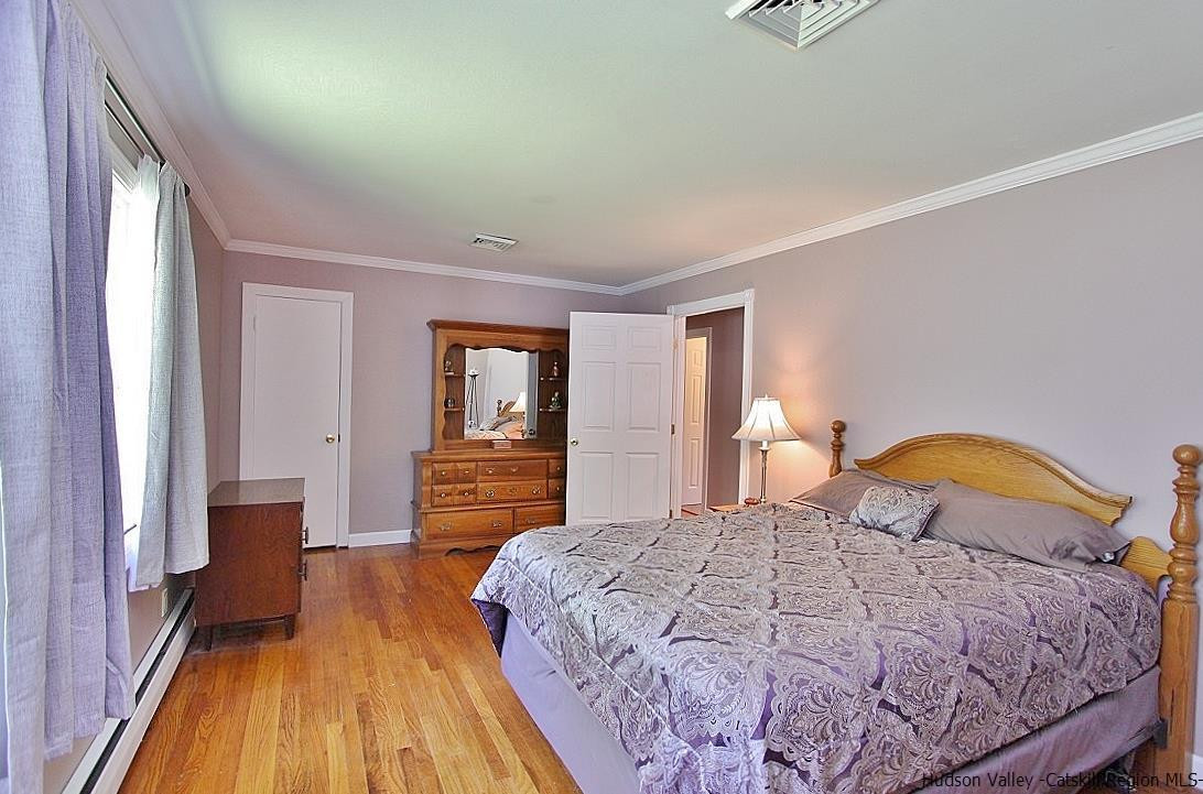 124 Blue Mountain Road Saugerties, NY 12477 - Photo 12 of 29 a bedroom with a bed and a dresser with rug