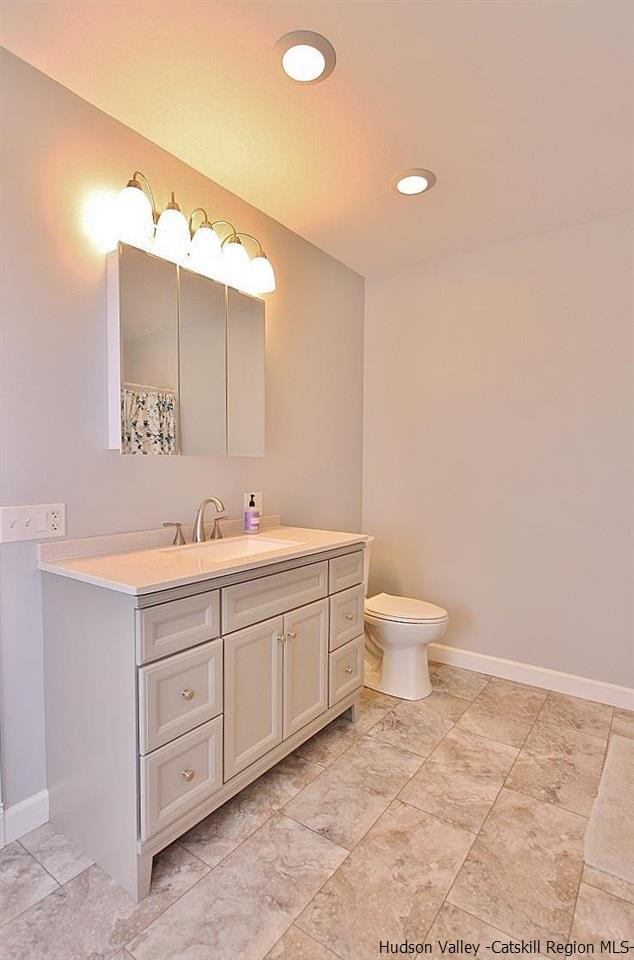 124 Blue Mountain Road Saugerties, NY 12477 - Photo 14 of 29 a bathroom with a double vanity sink mirror and toilet