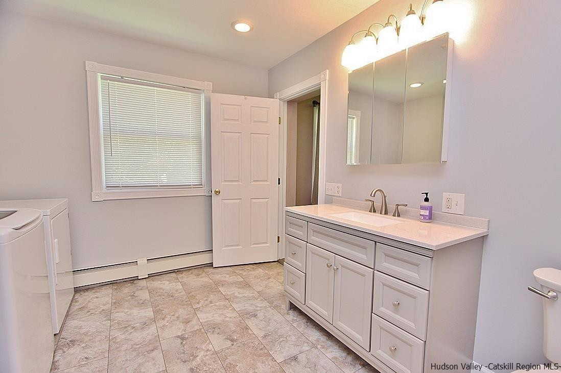 124 Blue Mountain Road Saugerties, NY 12477 - Photo 16 of 29 a bathroom with a sink and a mirror