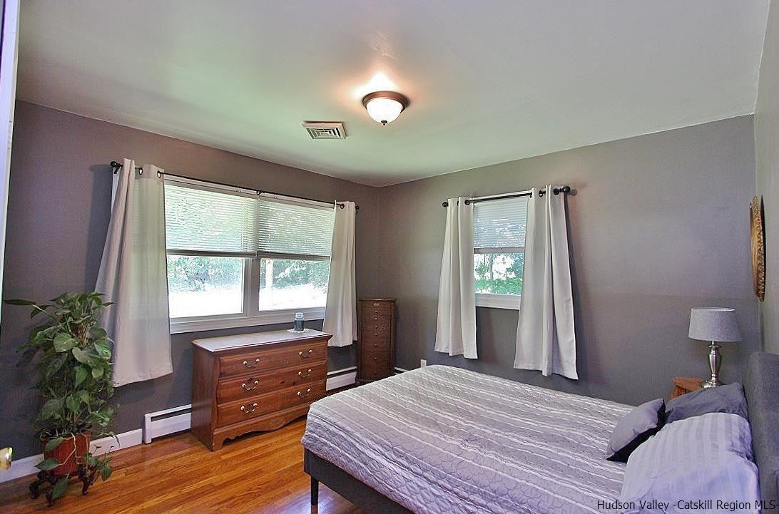 124 Blue Mountain Road Saugerties, NY 12477 - Photo 17 of 29 a bedroom with a bed and wooden floor