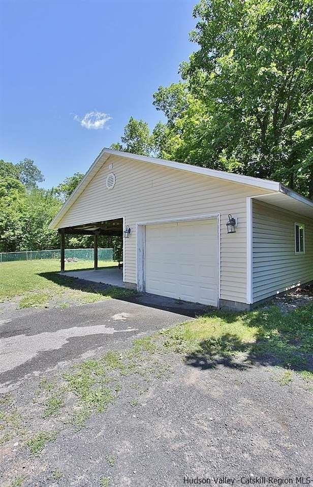 124 Blue Mountain Road Saugerties, NY 12477 - Photo 26 of 29 a front view of a house with a yard and garage