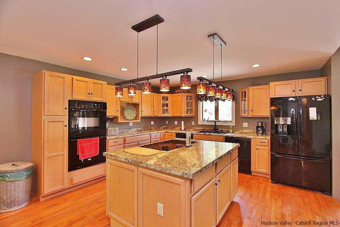 124 Blue Mountain Road Saugerties, NY 12477 - Photo 6 of 29 a kitchen with stainless steel appliances granite countertop a refrigerator a stove and a sink
