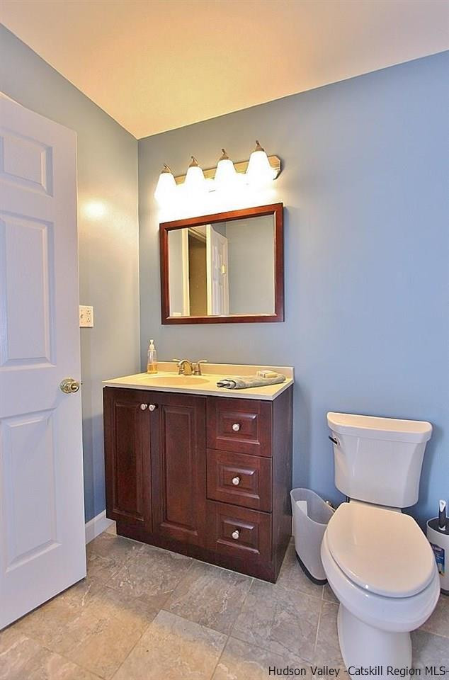 124 Blue Mountain Road Saugerties, NY 12477 - Photo 8 of 29 a bathroom with a toilet sink and mirror