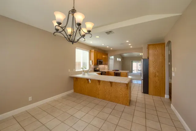 a kitchen with stainless steel appliances granite countertop a sink and cabinets