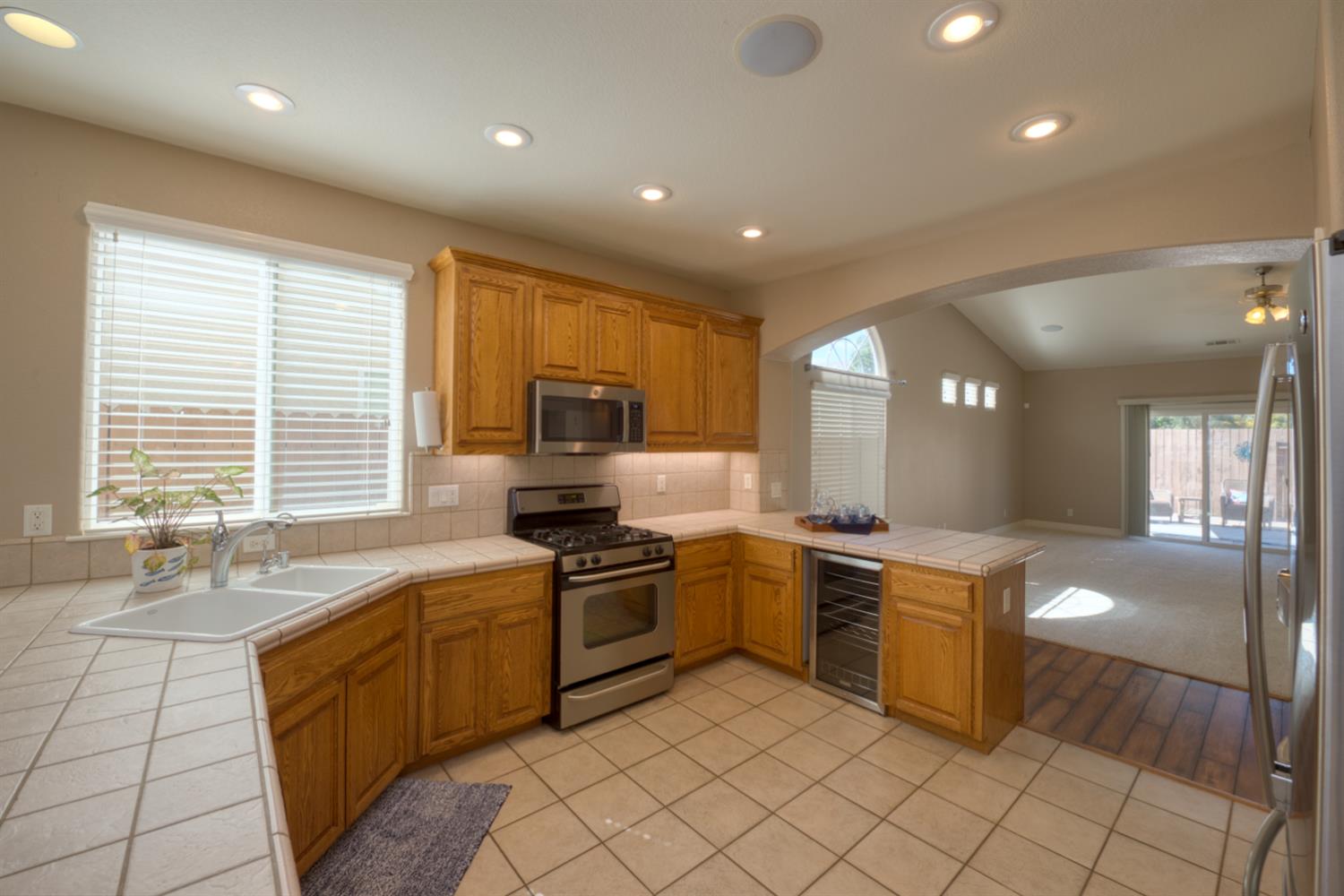 849 Miraggio Drive Patterson, CA 95363 - Photo 13 of 40 a kitchen with stainless steel appliances granite countertop a sink and cabinets