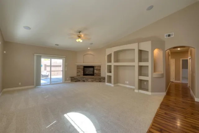 a living room with furniture a fireplace and a large window