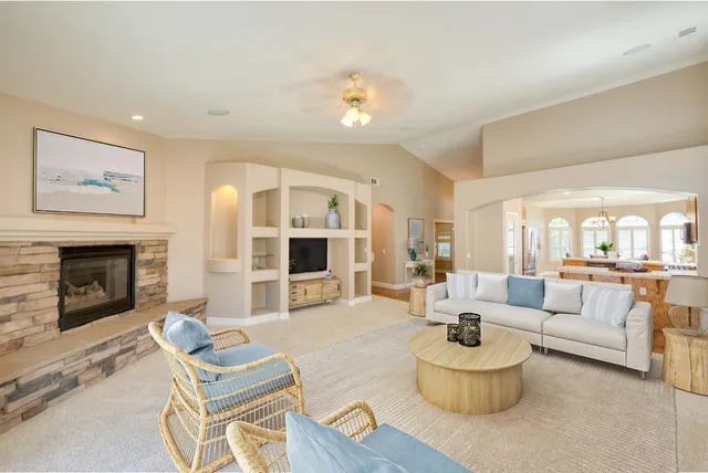 an empty room with furniture and a fireplace