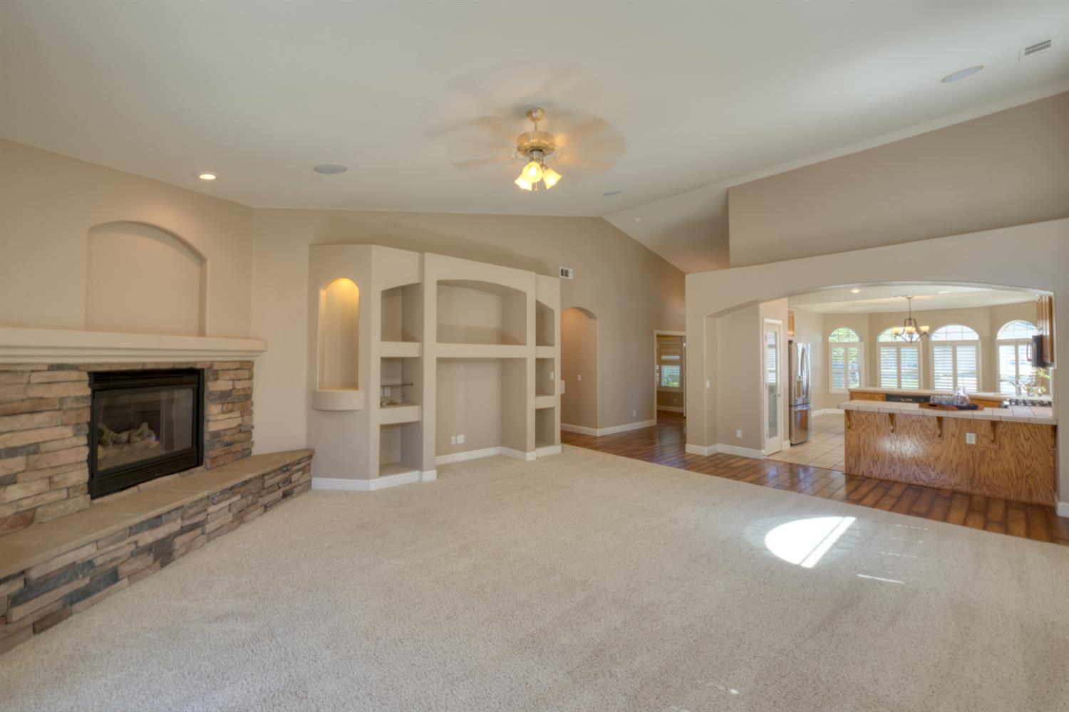 849 Miraggio Drive Patterson, CA 95363 - Photo 18 of 40 an empty room with furniture and a fireplace
