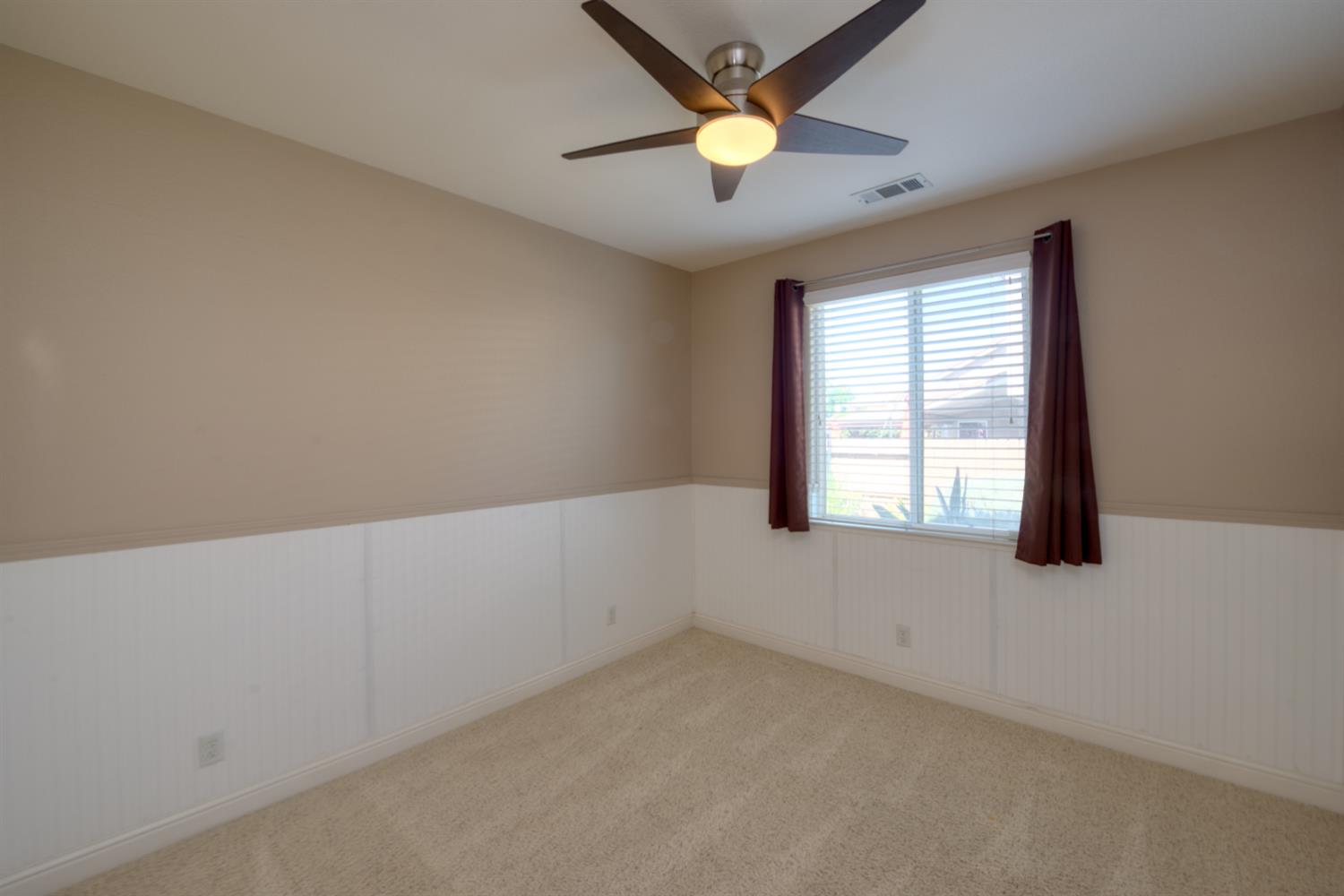 849 Miraggio Drive Patterson, CA 95363 - Photo 21 of 40 an empty room with a window and a fan