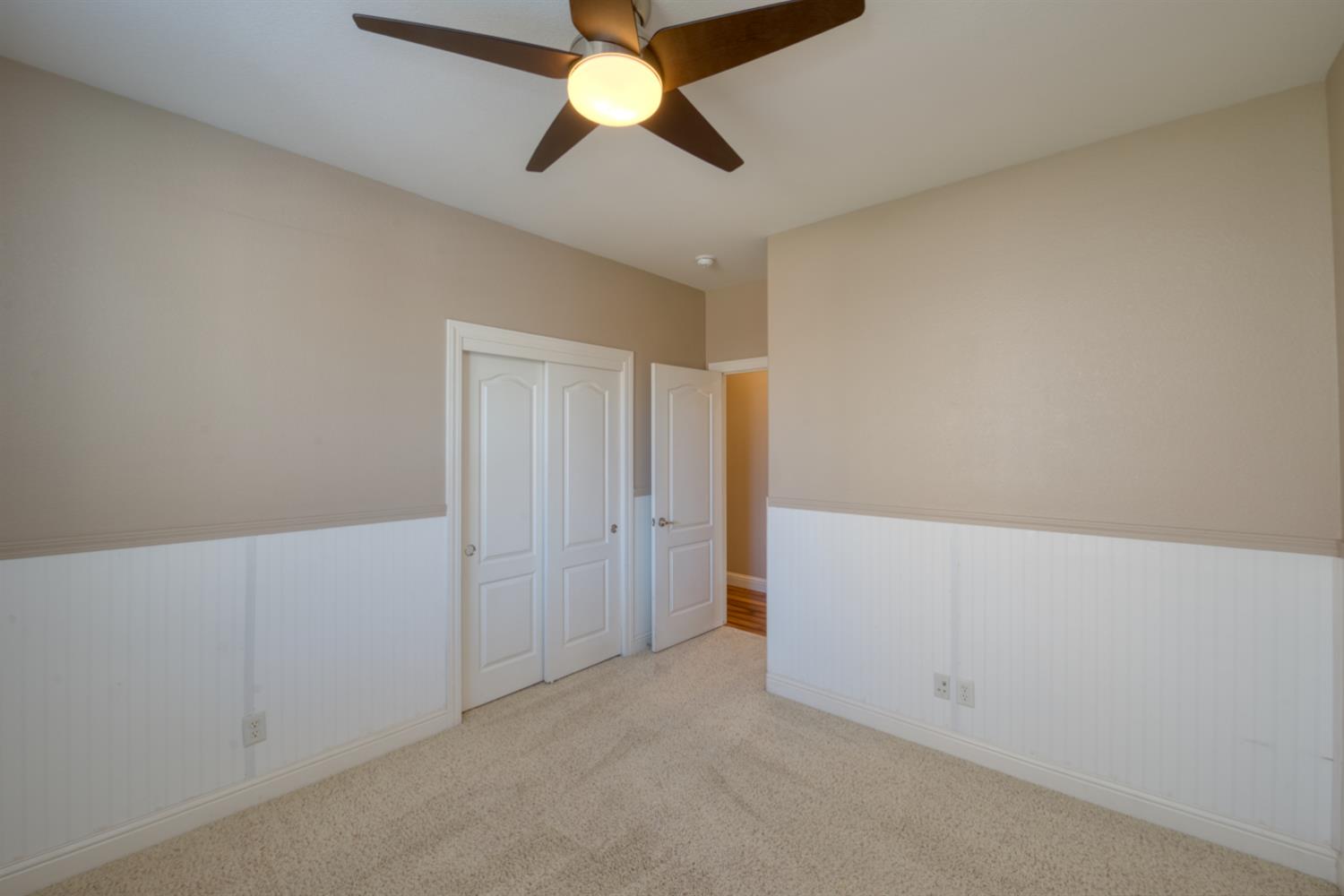 849 Miraggio Drive Patterson, CA 95363 - Photo 22 of 40 an empty room with a chandelier fan
