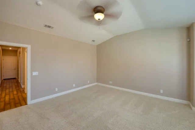 an empty room with windows and closet
