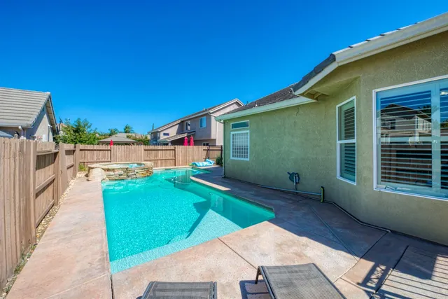 a view of backyard with a garden and deck