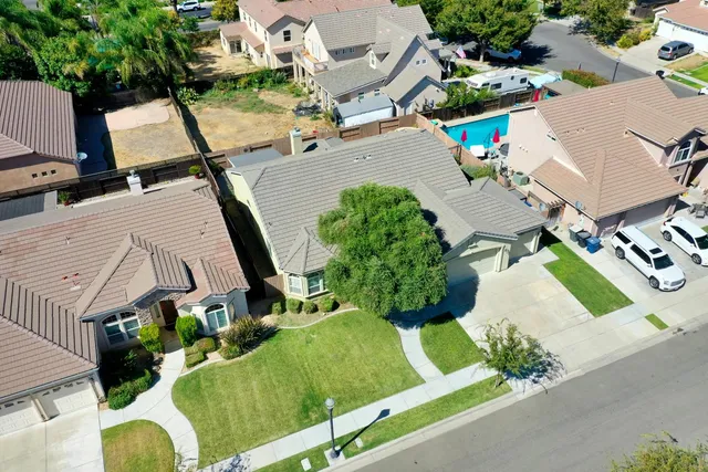 an aerial view of a house with a garden and mountain view