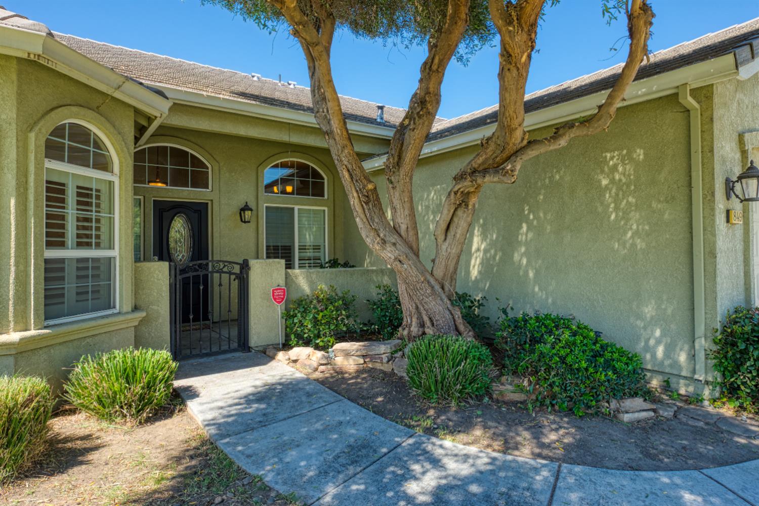 849 Miraggio Drive Patterson, CA 95363 - Photo 4 of 40 a front view of a house with a yard